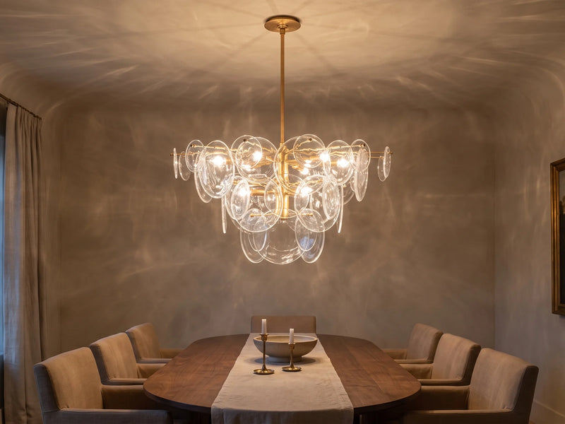 Tiered glass disc chandelier over a dining table