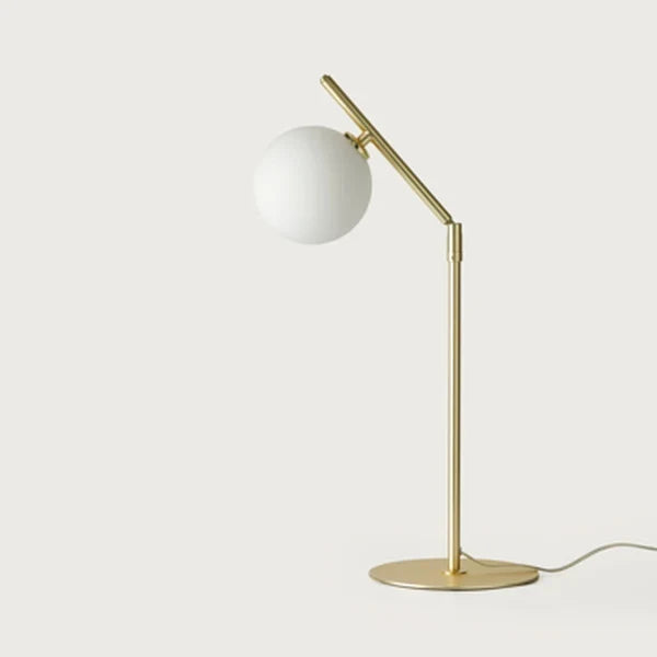 Adjustable arm opal glass globe lamp, in matte brass, front view