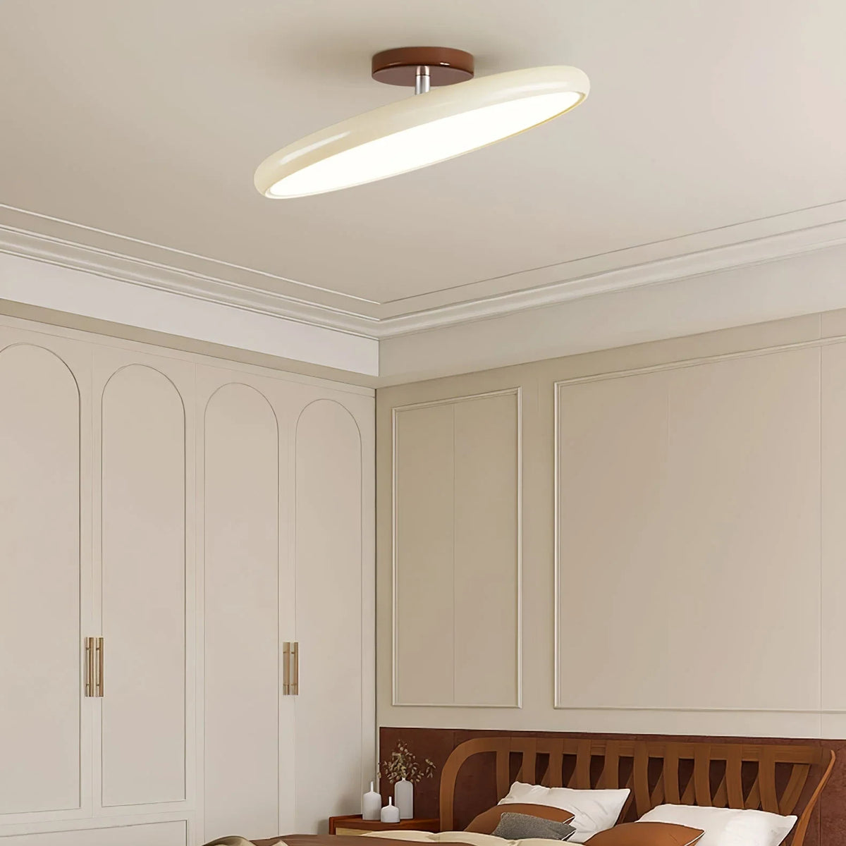 Tilting disc ceiling light, in beige in a bedroom