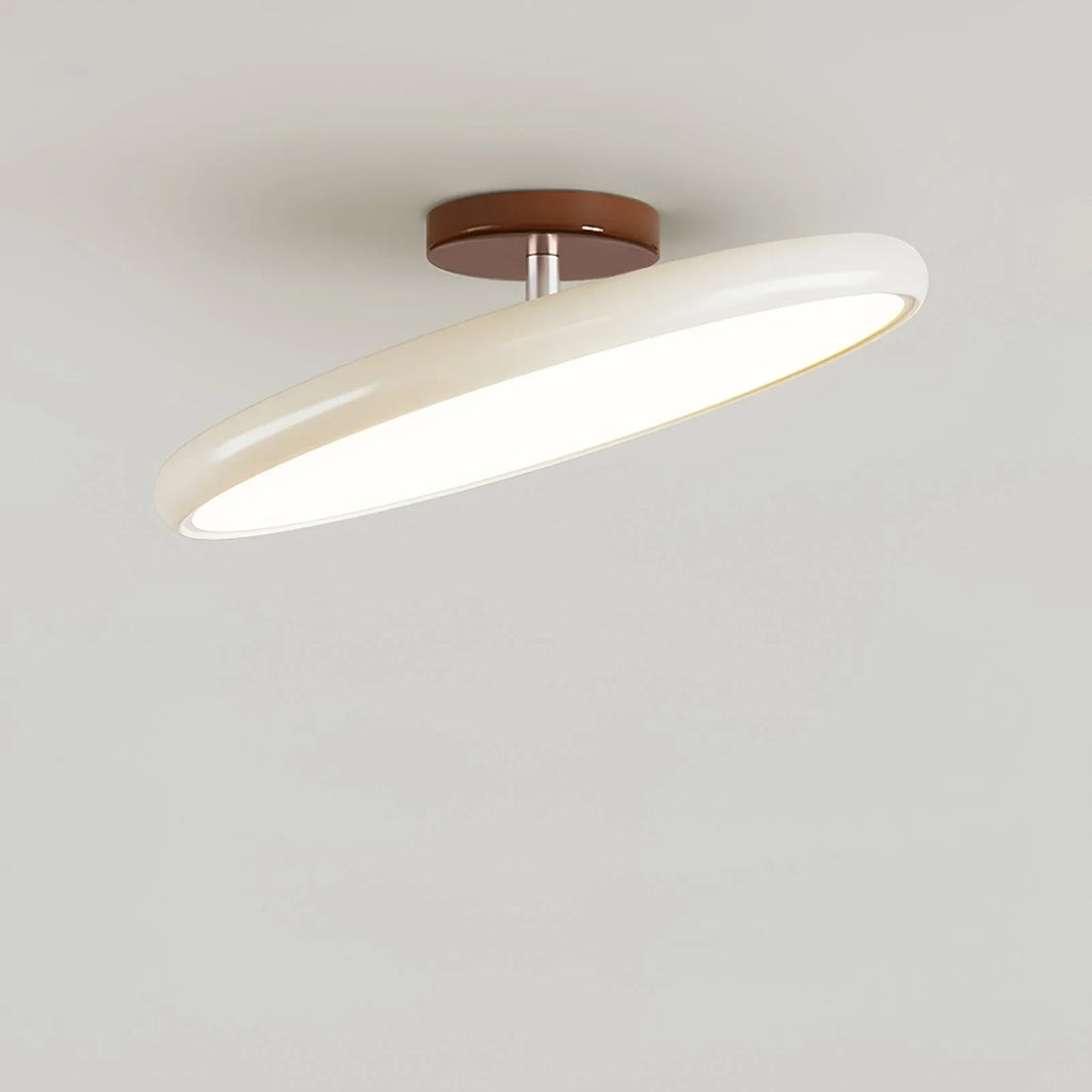Tilting disc ceiling light, in beige, tilted