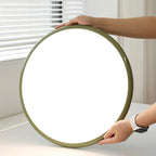 Tilting disc ceiling light, held to show its size