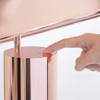 Adjustable cone shade steel table lamp, in Copper, a finger pressing the button