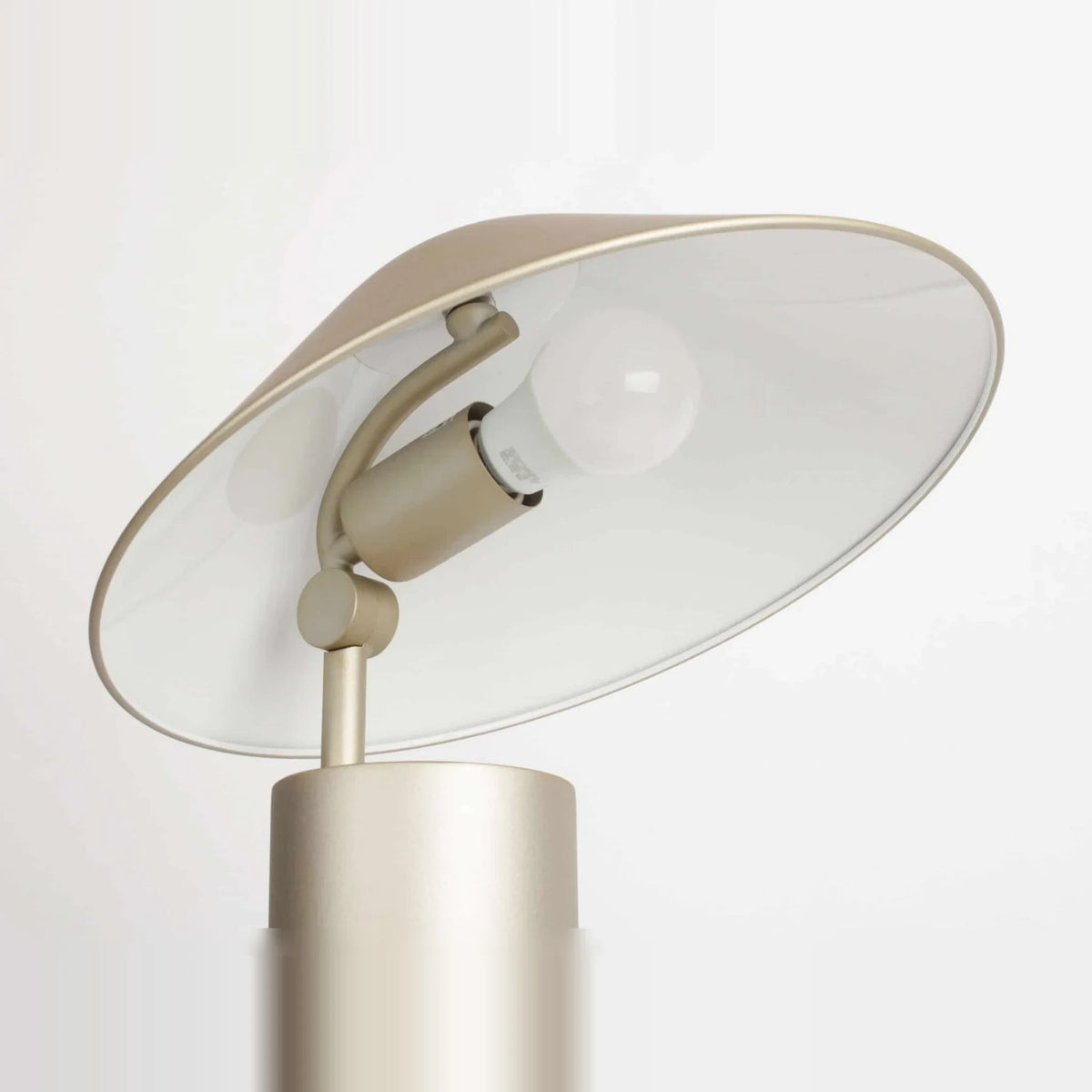 Adjustable cone shade steel table lamp, in Champagne Gold, underside of the shade and bulb