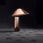 Adjustable cone shade steel table lamp, in Copper, lit in a dark room