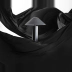 Adjustable cone shade steel table lamp, on a dark drape