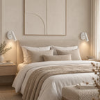 Adjustable reading wall light, a pair in white beside a bed