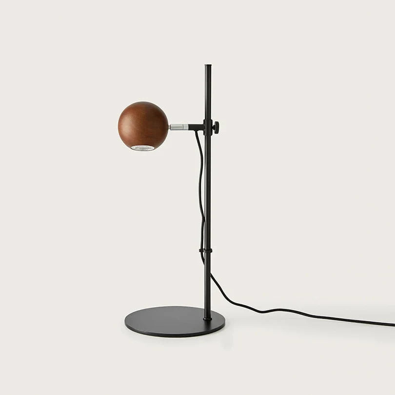 Adjustable round-head reading table lamp, with a walnut head, front view