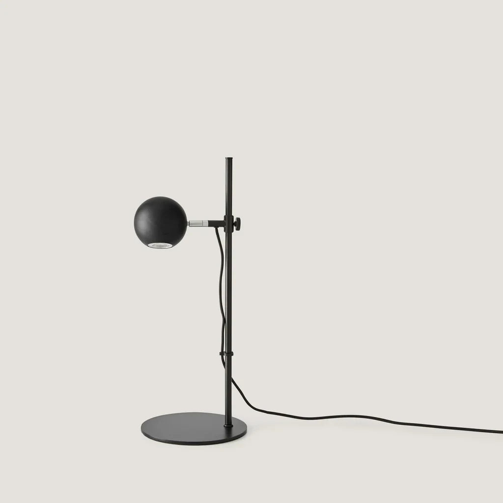 Adjustable round-head reading table lamp, with a matte black head, front view
