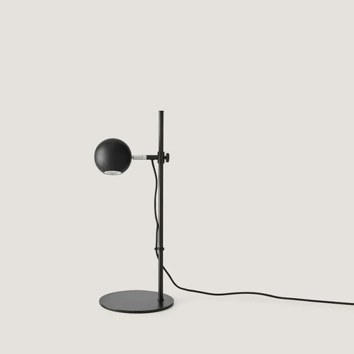 Adjustable round-head reading table lamp, with a matte black head, front view