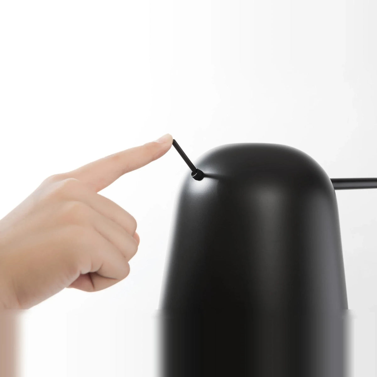 Adjustable shade steel floor lamp in black, close-up of the shade and switch