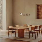 Alabaster cube linear pendant, above a long dining table