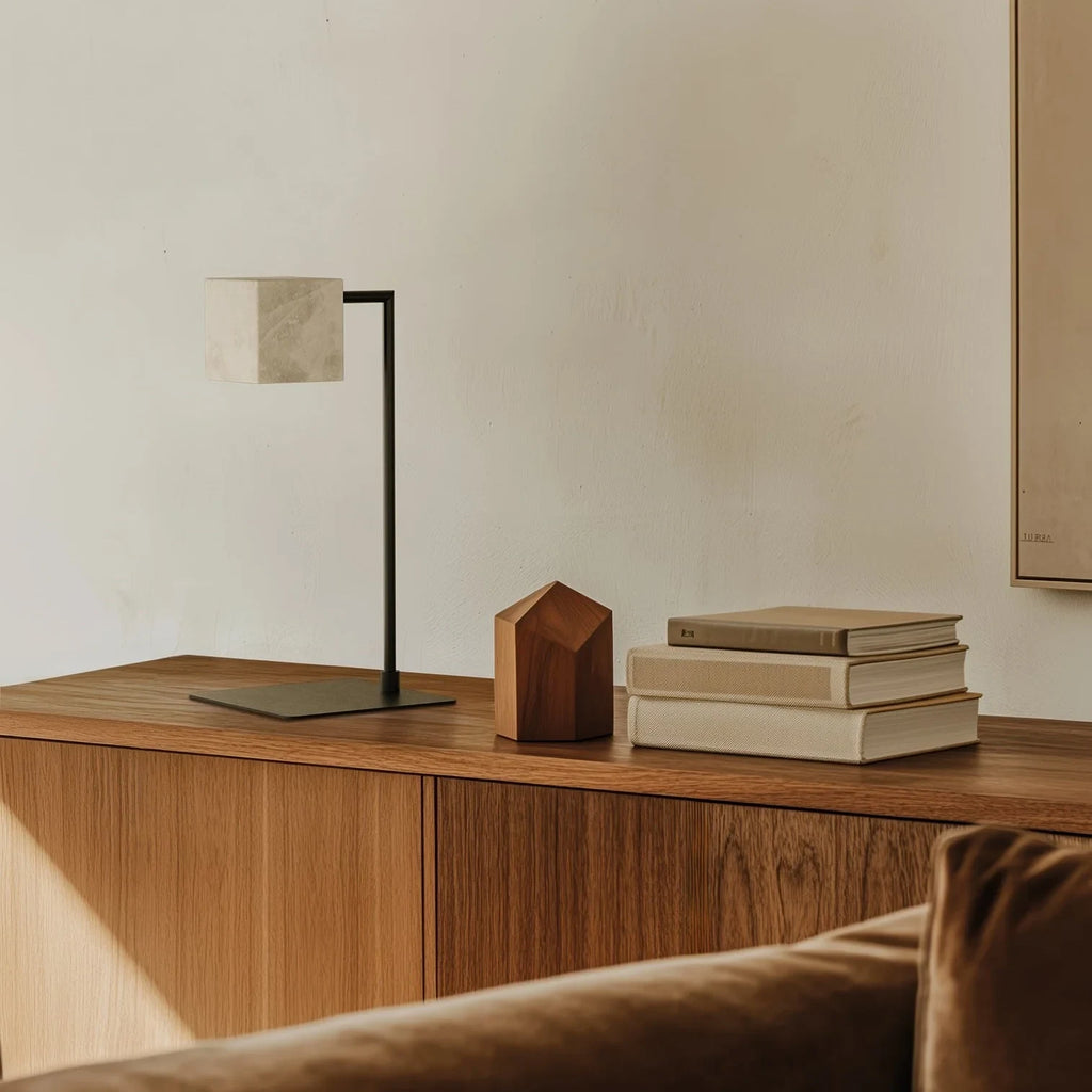 Alabaster cube table lamp with square stem, in matte black on a wooden sideboard