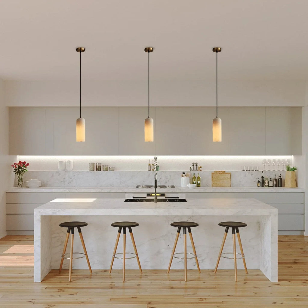 Alabaster cylinder pendant light, three above a kitchen island