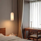Alabaster cylinder pendant light, beside a desk