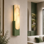 Alabaster panel wall light, in green, lit beside shelves