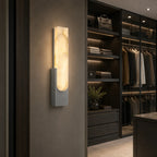 Alabaster panel wall light, in grey, lit in a dressing room