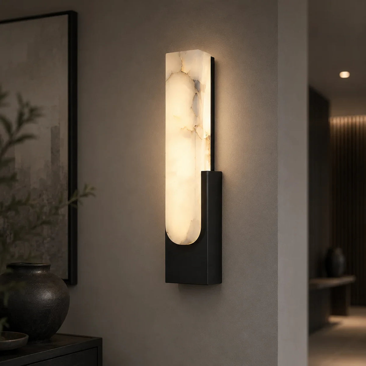 Alabaster panel wall light, in black, lit in a hallway