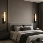 Alabaster panel wall light, a pair in black beside a bed