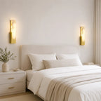 Alabaster panel wall light, a pair in gold beside a bed