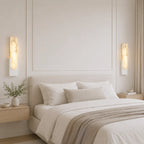 Alabaster panel wall light, a pair in white beside a bed