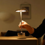Aluminium cordless table lamp, lit in a room setting