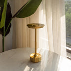 Aluminium cordless table lamp, lit in a room setting