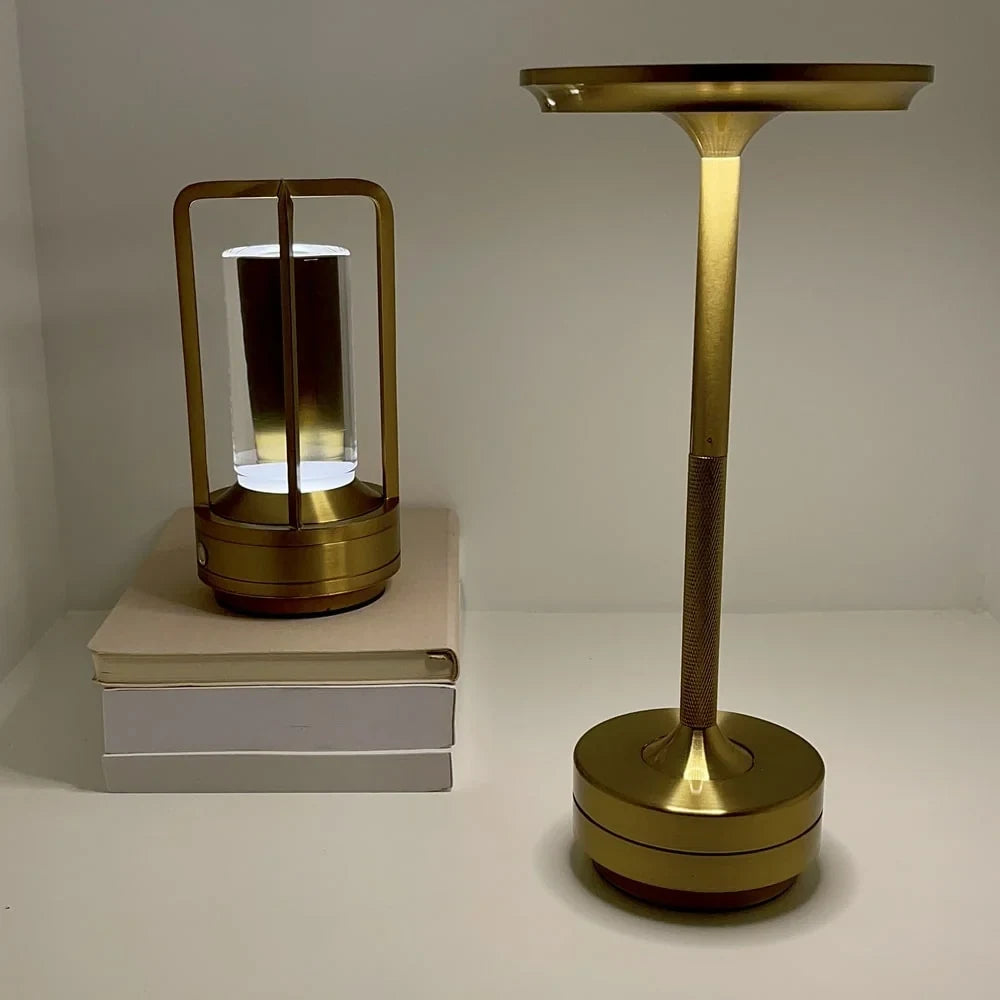Aluminium cordless table lamp, beside a smaller lantern lamp
