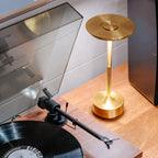 Aluminium cordless table lamp, beside a record player