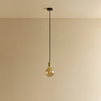 Amber filament globe bulb pendant, unlit against a plain wall