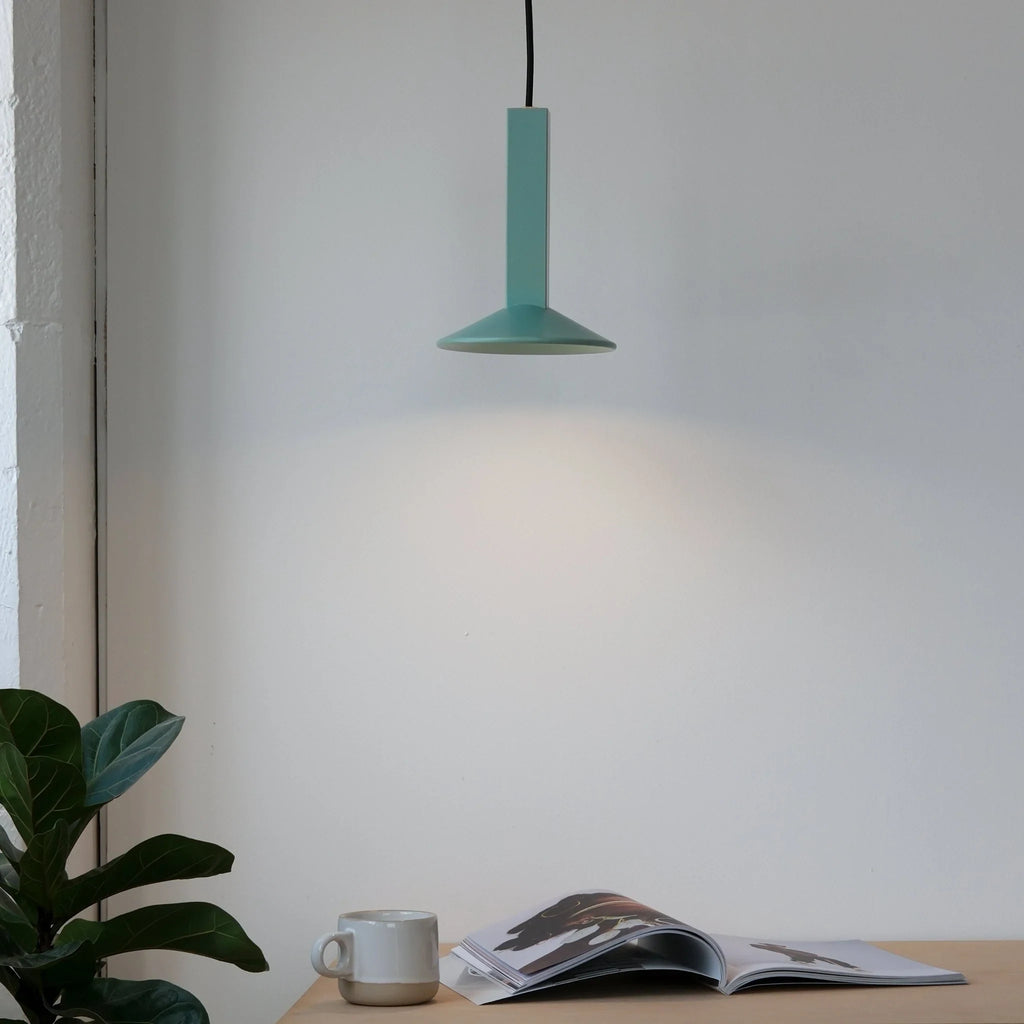 Angular stoneware spot pendant, in Bermuda green above a desk
