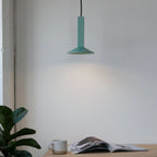 Angular stoneware spot pendant, in Bermuda green above a desk