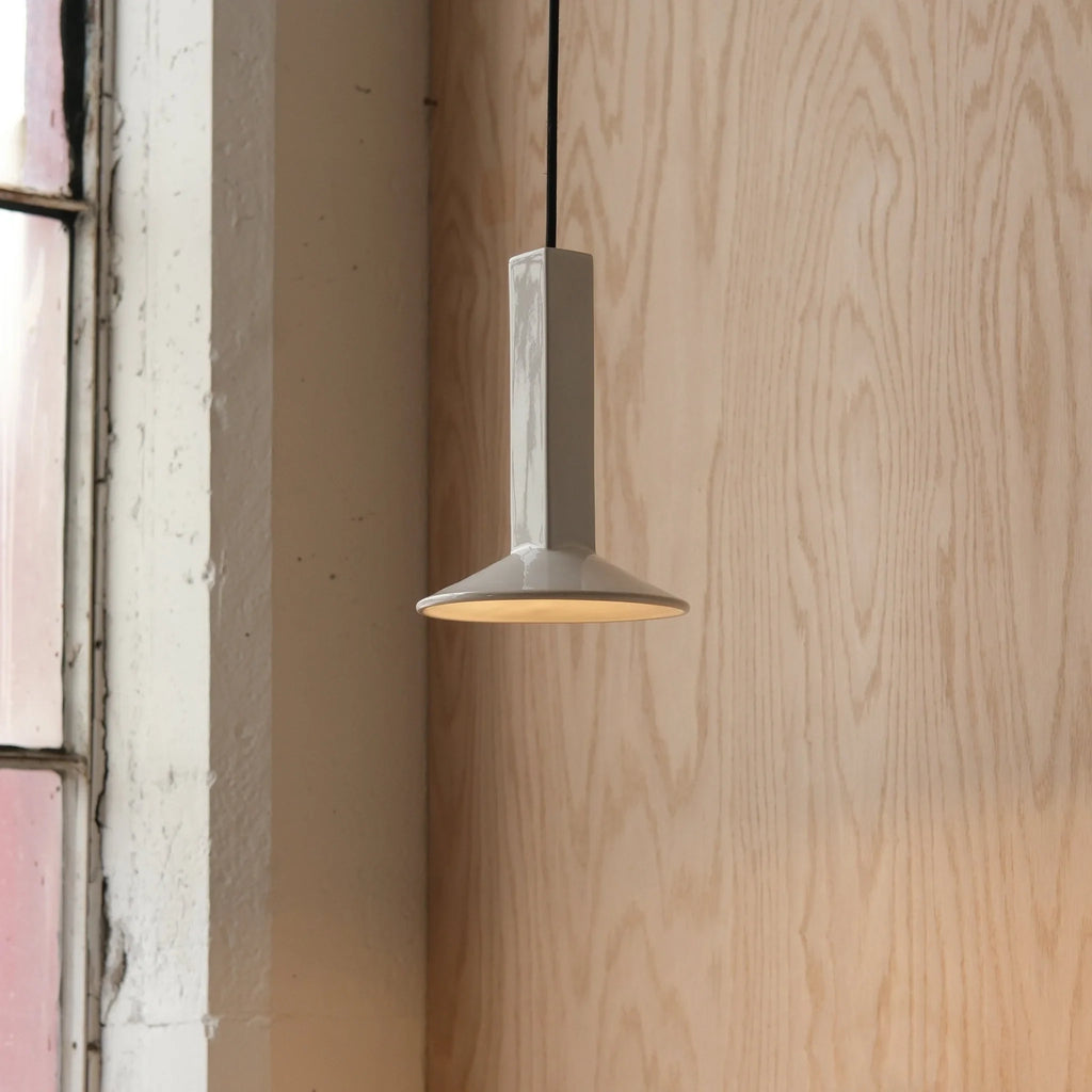 Angular stoneware spot pendant, in white by a window