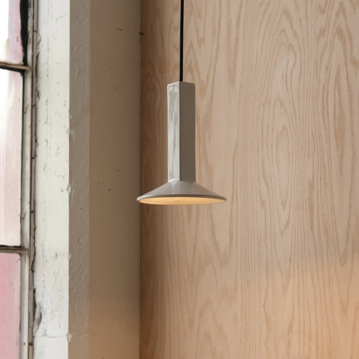 Angular stoneware spot pendant, in white by a window