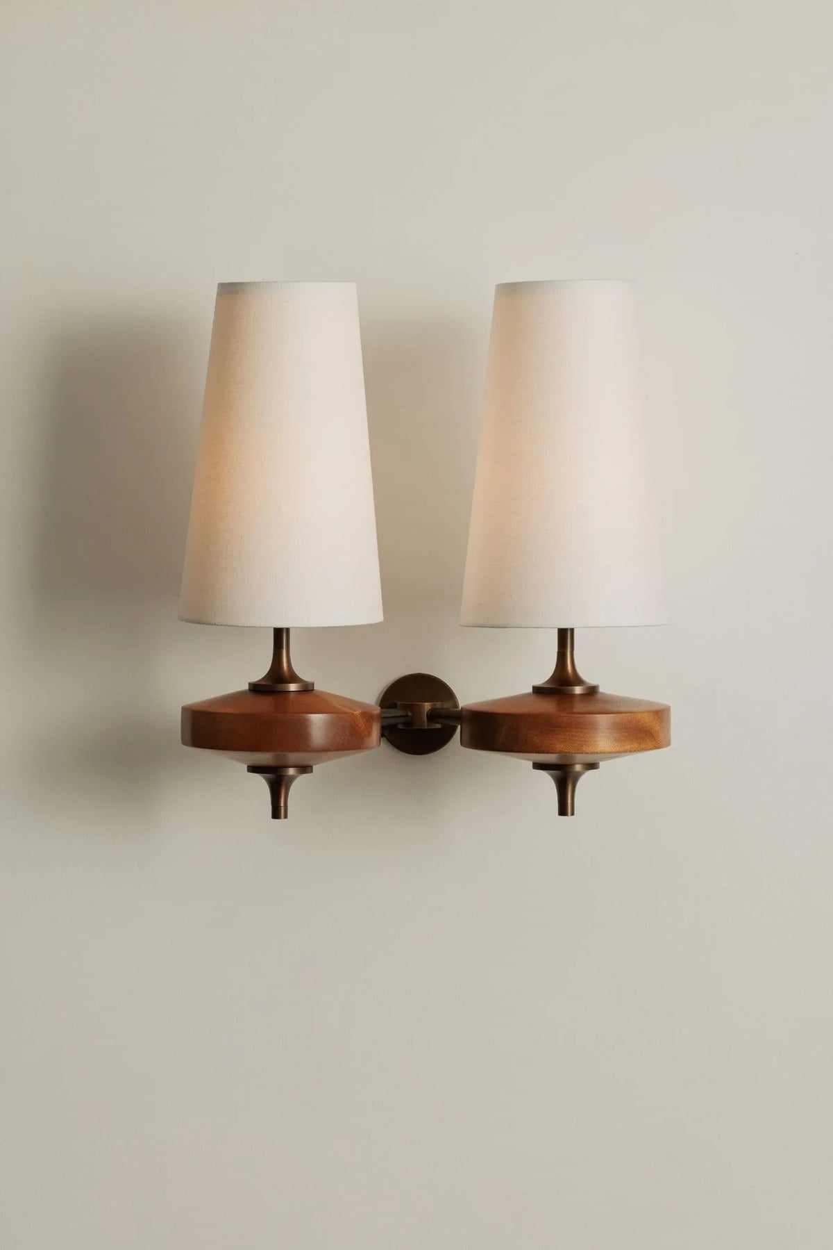 Walnut and antique brass wall light, double, white shades