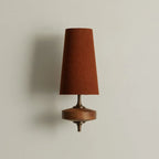 Walnut and antique brass wall light, single, with a red shade