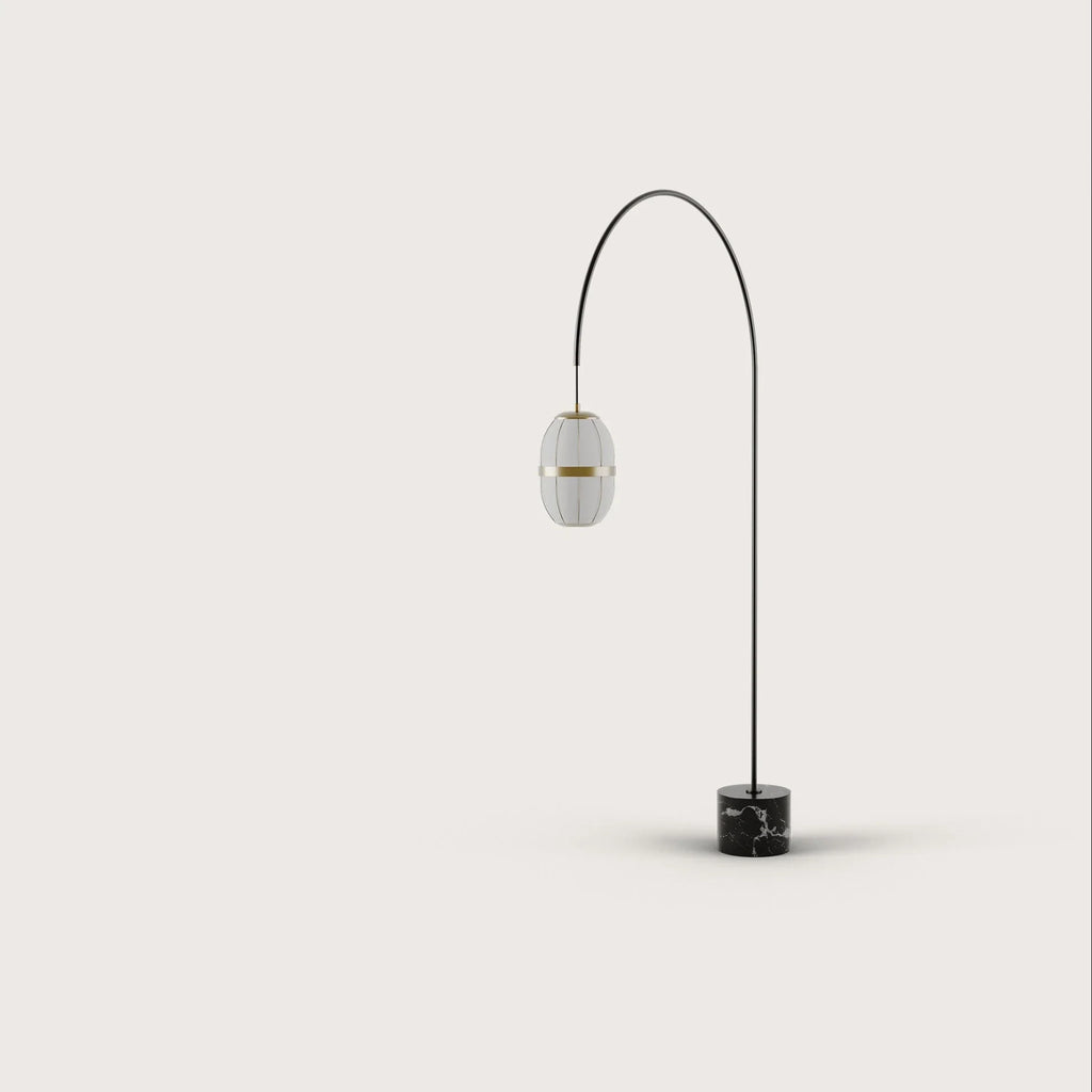 Arc floor lamp with a ribbed lantern shade and black marble foot, on a plain background