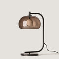 Arched table lamp with domed shade, in matte black with smoked glass, front view