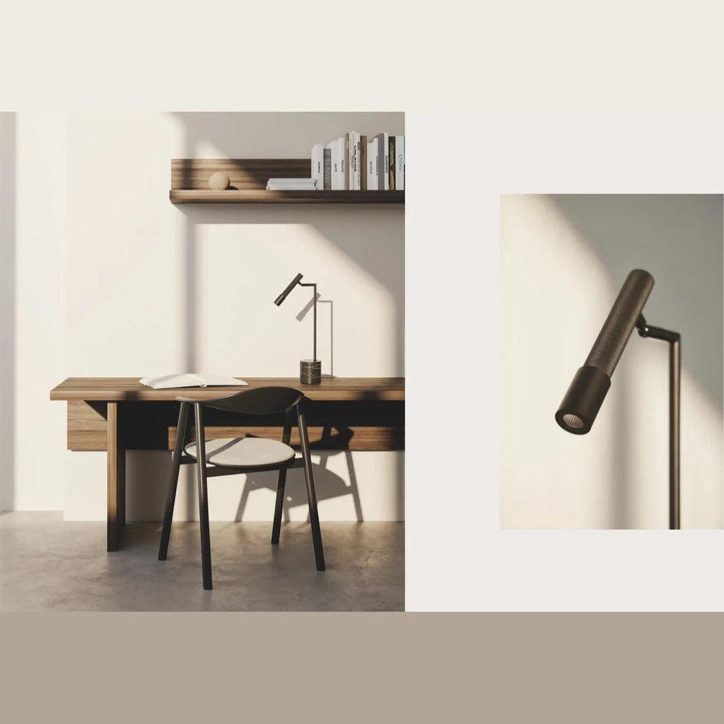 Articulated LED reading table lamp, black marble base, on a desk