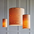 Large ash veneer drum pendant, lit, grouped with the small size