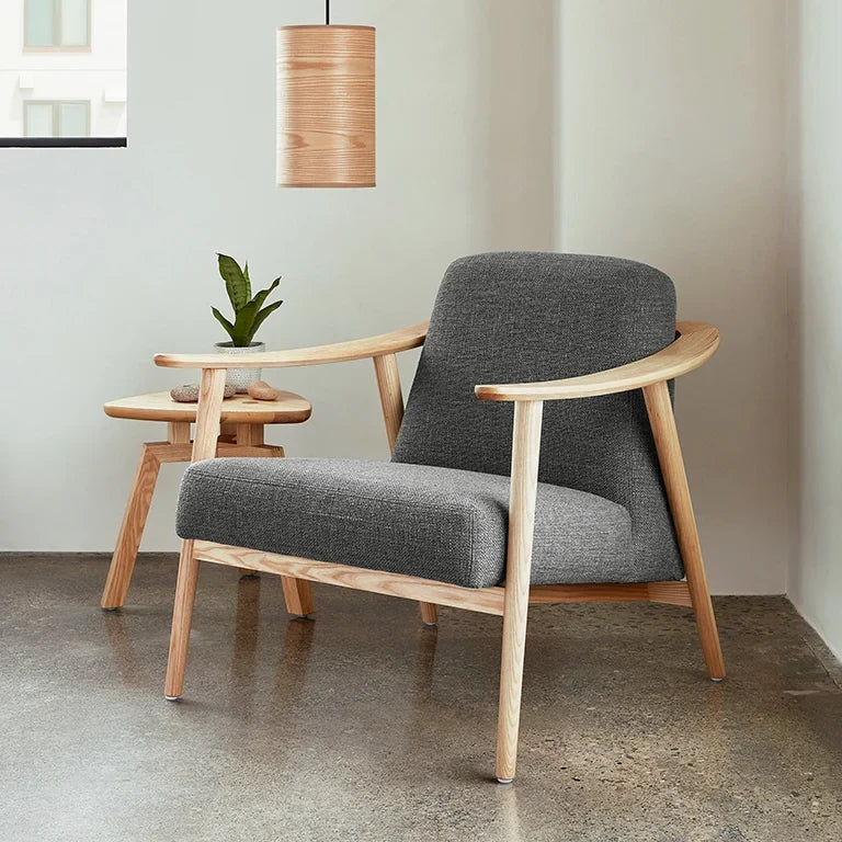 Small ash veneer drum pendant, above a lounge chair
