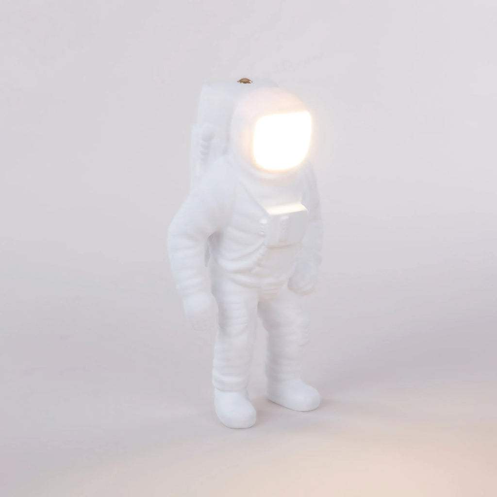 Astronaut cordless table lamp in white resin, lit, three-quarter view