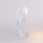 Astronaut cordless table lamp in white resin, lit, side view