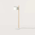 Beech upright floor lamp with an offset white drum shade, on a plain background