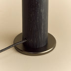 Blackened oak bulb holder table lamp, close-up of the gunmetal base and cable