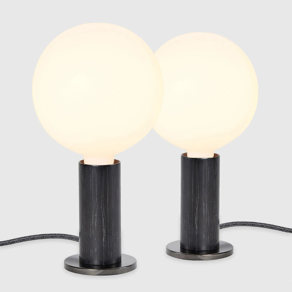 Blackened oak table lamp pair, opal globe bulbs, on a white background