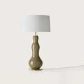 Bottle-shaped glass table lamp, in olive green, with a white shade (not included)