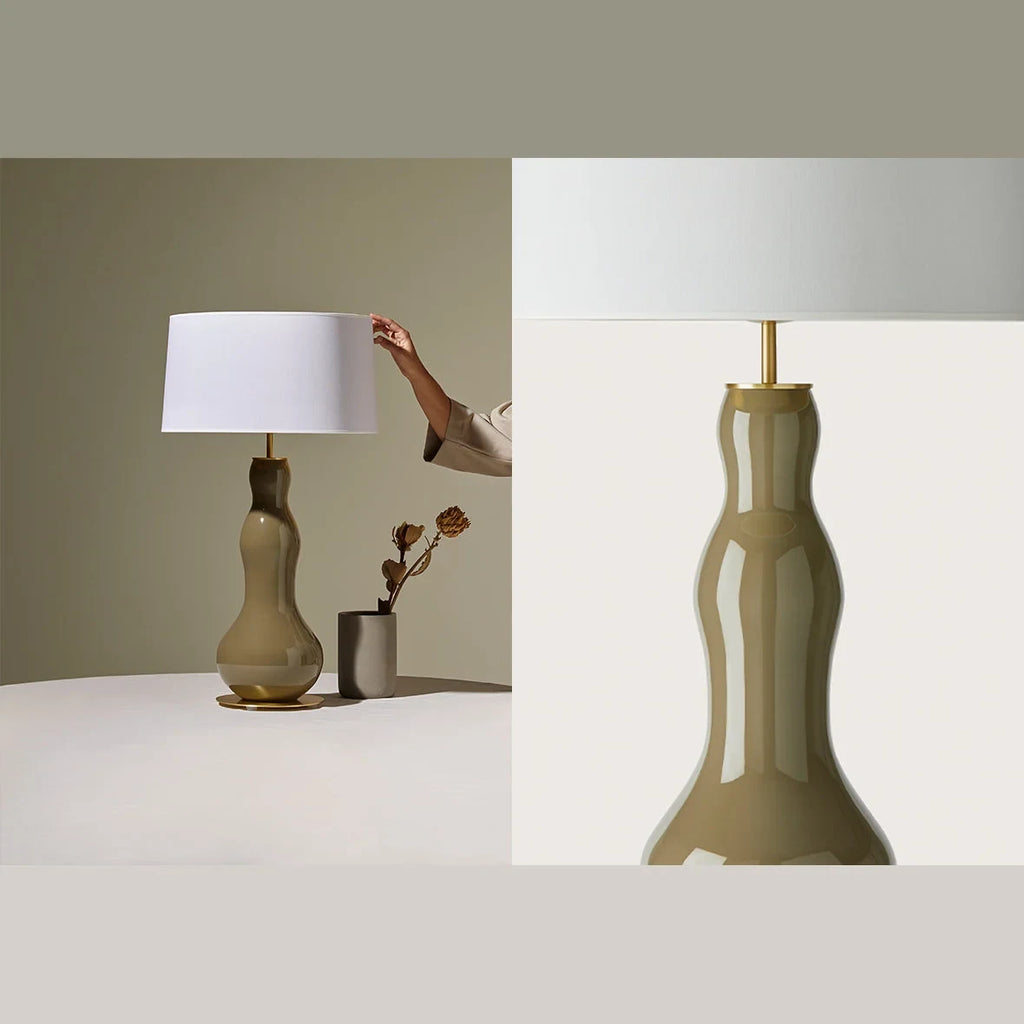 Bottle-shaped glass table lamp, in a styled corner, with a shade (not included)