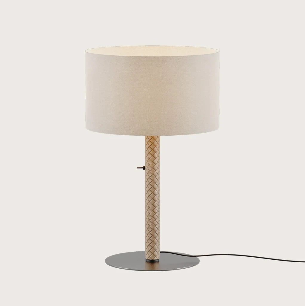 Braided leather column table lamp with drum shade, showing the metallic disc base