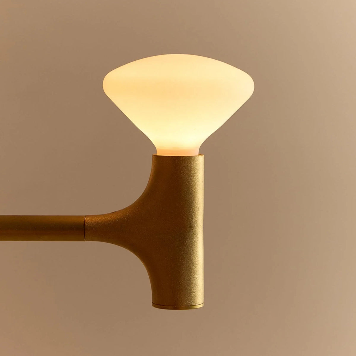 Branching brass chandelier, close-up of a glowing bulb