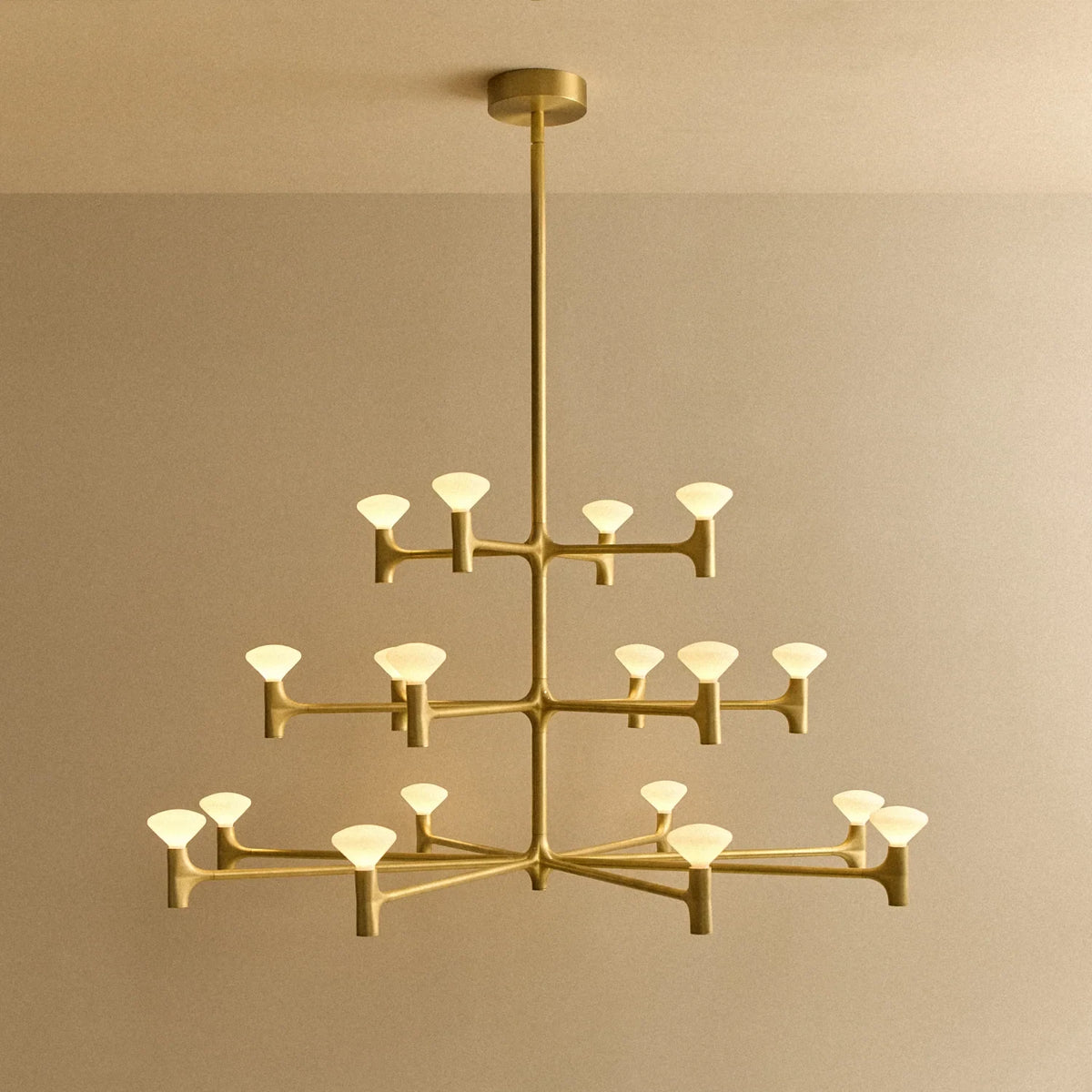 Branching brass chandelier, lit, three tiers